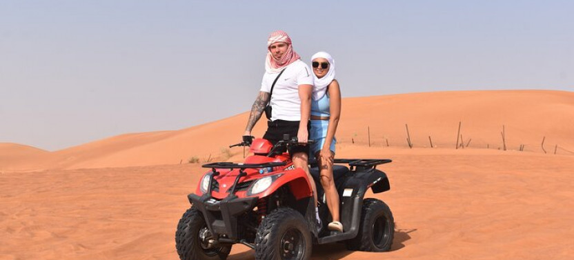 Sunset Desert Safari with Quad Bike, Camel Ride, Sand Board, & BBQ Dinner