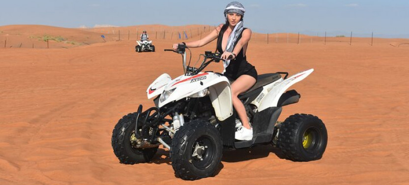 Sunset Desert Safari with Quad Bike, Camel Ride, Sand Board, & BBQ Dinner