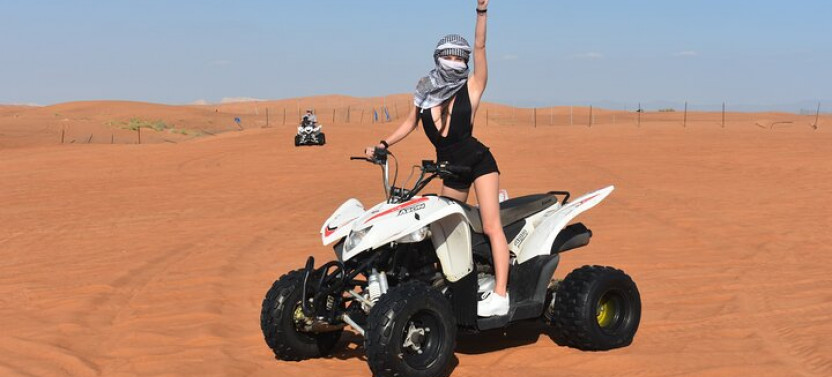 Sunset Desert Safari with Quad Bike, Camel Ride, Sand Board, & BBQ Dinner