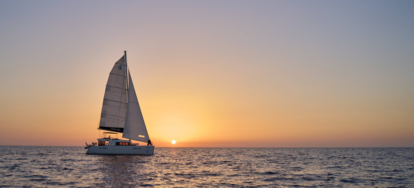 Private Sunset Catamaran Cruise with BBQ, Open Bar & Exclusive Transfers
