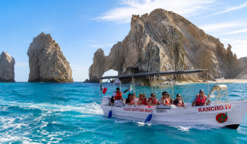 A picture of Arch, Lover's beach with Glass Bottom Boat .