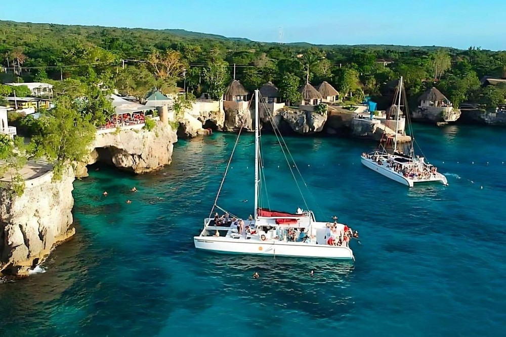 Early Bird Morning Catamaran Cruise Reef & Caves All Resorts